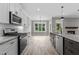 Modern kitchen with stainless steel appliances, granite countertops, and an island with a sink at 75 Woodbark Cv # 10, Willow Springs, NC 27592