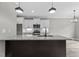 Modern kitchen featuring a central island, white cabinets and stainless steel appliances at 75 Woodbark Cv # 10, Willow Springs, NC 27592