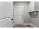 Bright laundry room featuring white cabinets, a utility sink, and plenty of storage at 75 Woodbark Cv # 10, Willow Springs, NC 27592