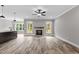 Open living room featuring a fireplace, abundant natural light, and hardwood floors at 75 Woodbark Cv # 10, Willow Springs, NC 27592