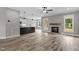 Bright living room with hardwood floors, fireplace, and open concept leading to the kitchen at 75 Woodbark Cv # 10, Willow Springs, NC 27592