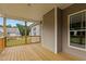 Covered back porch features natural wood decking and railing with an outdoor view at 75 Woodbark Cv # 10, Willow Springs, NC 27592