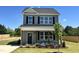 Charming two-story home with gray siding, black shutters, and manicured front lawn at 40 Longbow Dr, Middlesex, NC 27557