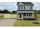 Charming two-story home with gray siding, black shutters, and a well-manicured front lawn at 40 Longbow Dr, Middlesex, NC 27557