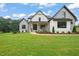 Charming two-story home with black trim, a covered porch, and lush green lawn at 1804 Stream Manor Ct, Wake Forest, NC 27587