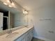 A bright bathroom featuring double sinks, quartz countertops, and a large mirror to enhance the space at 492 Traditions Grande Blvd # 26, Wake Forest, NC 27587