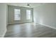 Light-filled bedroom boasts neutral walls, wood floors, recessed lights, and large windows for natural light at 492 Traditions Grande Blvd # 26, Wake Forest, NC 27587