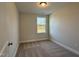 A cozy bedroom with neutral carpeting, a bright window, and ample natural light makes this space inviting and comfortable at 492 Traditions Grande Blvd # 26, Wake Forest, NC 27587