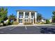 Modern clubhouse featuring large windows, stone accents, and manicured landscaping offers a community gathering space at 492 Traditions Grande Blvd # 26, Wake Forest, NC 27587