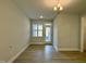 Empty dining room with neutral walls, wood floors, modern lighting, and lots of natural light at 492 Traditions Grande Blvd # 26, Wake Forest, NC 27587