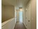 A carpeted hallway with neutral walls and multiple doors showcases the layout and flow of the home at 492 Traditions Grande Blvd # 26, Wake Forest, NC 27587