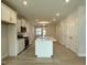 Bright kitchen featuring a central island, white cabinets, and modern appliances at 492 Traditions Grande Blvd # 26, Wake Forest, NC 27587