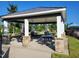 Community picnic pavilion with multiple picnic tables and stone pillar supports at 492 Traditions Grande Blvd # 26, Wake Forest, NC 27587