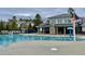 Community pool featuring a club building with stone accents at 492 Traditions Grande Blvd # 26, Wake Forest, NC 27587