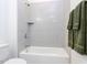 Bright bathroom featuring a shower-tub combination and neutral-toned tile at 804 Ambercrest Place, Durham, NC 27705