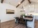 Dining area features wood table, chandelier lighting, and open view of the kitchen at 804 Ambercrest Place, Durham, NC 27705