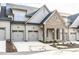 Charming townhome showcasing a two-car garage, brick accents, and manicured landscaping at 804 Ambercrest Place, Durham, NC 27705