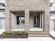 Inviting entrance featuring a brick-columned porch and a stylish wood front door at 804 Ambercrest Place, Durham, NC 27705