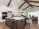 Open-concept kitchen with a vaulted ceiling, an island, modern appliances, and hardwood floors at 804 Ambercrest Place, Durham, NC 27705