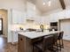 Modern kitchen featuring a center island, bar seating, and stainless steel appliances at 804 Ambercrest Place, Durham, NC 27705