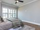 This main bedroom features hardwood floors, multiple windows, and neutral paint colors at 804 Ambercrest Place, Durham, NC 27705