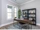 Home office featuring a sleek desk, shelving, and natural light from a window at 804 Ambercrest Place, Durham, NC 27705