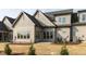 Back of home featuring a concrete patio and windows with beige siding and black roof at 804 Ambercrest Place, Durham, NC 27705