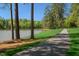 Scenic walking path near the lake, with lush trees and blue skies at 804 Ambercrest Place, Durham, NC 27705