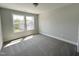 Well-lit bedroom with two windows and carpet flooring at 524 Jones Bluff Way, Knightdale, NC 27545