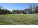 Expansive lot with a charming home, storage shed, and lush landscaping, providing a serene and inviting atmosphere at 2913 Wadsworth Ave, Durham, NC 27707