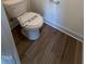 Close up view of the toilet and wood-look flooring in the bathroom at 103 Sage Ln # 009, Four Oaks, NC 27524
