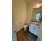 Bathroom featuring a toilet, wood-look floors, granite vanity and mirror at 103 Sage Ln # 009, Four Oaks, NC 27524