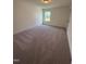 Another bedroom with a window and neutral carpet at 103 Sage Ln # 009, Four Oaks, NC 27524