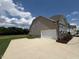 This home features an attached two car garage with a concrete driveway and lush green lawn at 103 Sage Ln # 009, Four Oaks, NC 27524