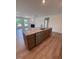 Kitchen island with a stone countertop, stainless dishwasher, and wood cabinets at 103 Sage Ln # 009, Four Oaks, NC 27524