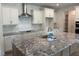Modern kitchen featuring granite countertops, stainless steel appliances, and ample storage at 103 Sage Ln # 009, Four Oaks, NC 27524