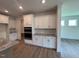 Modern kitchen with white cabinets and granite countertops at 103 Sage Ln # 009, Four Oaks, NC 27524