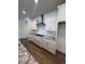 Modern kitchen with stone countertops, stainless hood and white cabinetry at 103 Sage Ln # 009, Four Oaks, NC 27524
