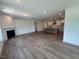 Living room with an open floor plan flowing to the modern kitchen at 103 Sage Ln # 009, Four Oaks, NC 27524