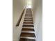 Carpeted staircase with wooden handrail leading to the upper level at 103 Sage Ln # 009, Four Oaks, NC 27524