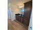 Bathroom featuring wood-look floors, dark vanity with black countertop, and framed mirror at 123 Sage Ln # 010, Four Oaks, NC 27524