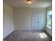 Neutral bedroom featuring carpet, a double-door closet and natural light from a window at 123 Sage Ln # 010, Four Oaks, NC 27524