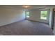 Spacious carpeted bedroom features two large windows and ample natural light at 123 Sage Ln # 010, Four Oaks, NC 27524