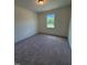 Bedroom featuring neutral carpet and a view of the outdoors through a window at 123 Sage Ln # 010, Four Oaks, NC 27524