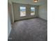 Spacious carpeted bedroom features two large windows and ample natural light at 123 Sage Ln # 010, Four Oaks, NC 27524