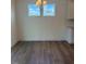 Bright dining area with wood floors and a modern chandelier fixture under two windows at 123 Sage Ln # 010, Four Oaks, NC 27524