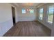 Bright dining room featuring hardwood floors, wainscoting, modern chandelier, and multiple windows at 123 Sage Ln # 010, Four Oaks, NC 27524