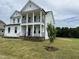 Beautiful new home boasting a double porch, well manicured lawn and fresh landscaping at 123 Sage Ln # 010, Four Oaks, NC 27524