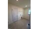 A functional laundry room with tile flooring and a convenient storage shelf at 123 Sage Ln # 010, Four Oaks, NC 27524