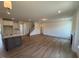 Open-concept living room showcasing hardwood floors, a fireplace, and a kitchen island at 123 Sage Ln # 010, Four Oaks, NC 27524